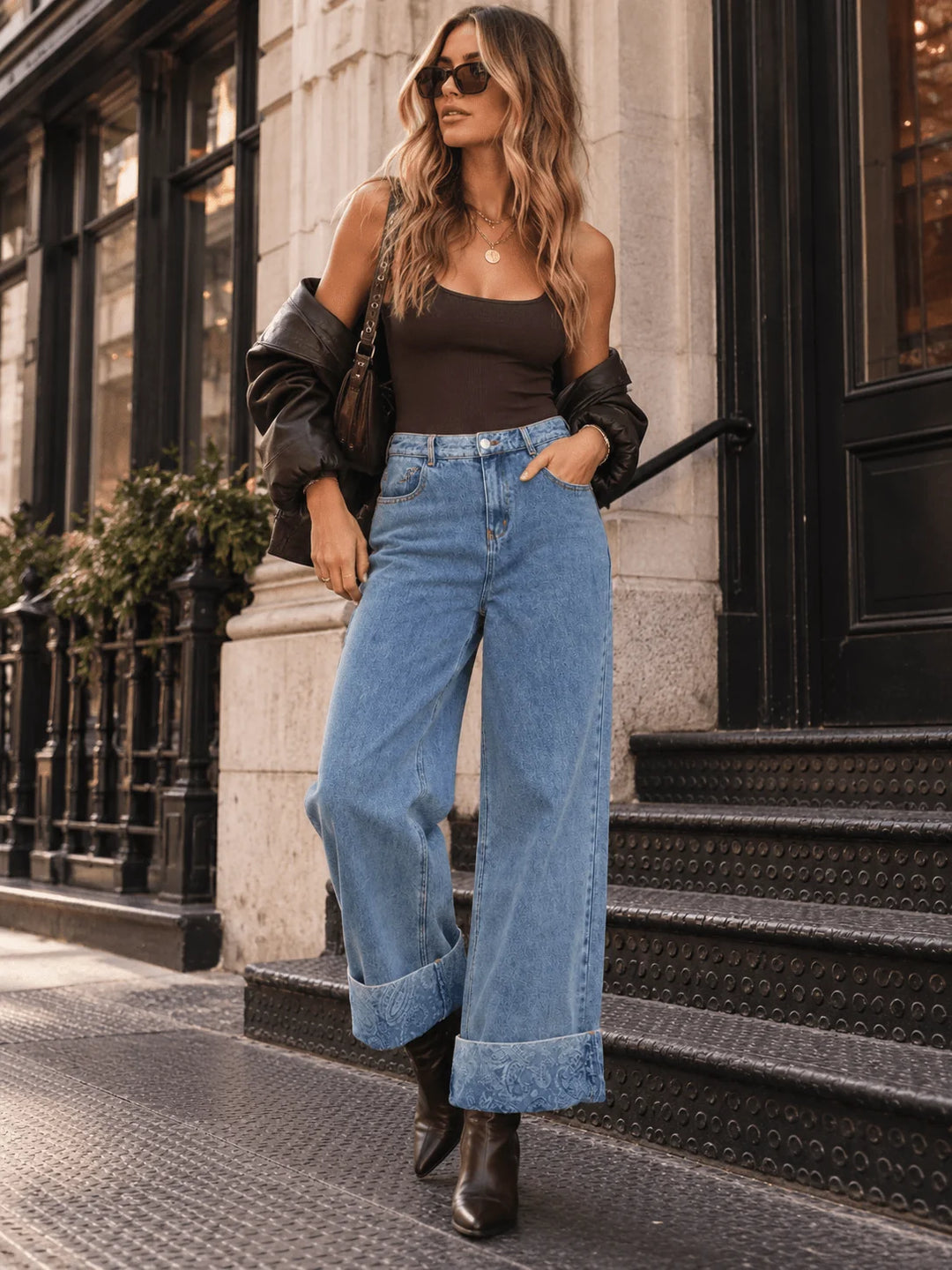 Wide-leg jeans with oversized turned-up cuffs featuring subtle floral detailing